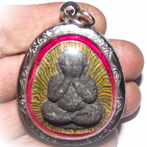 Front face of the Amulet held in the hand to show its large size