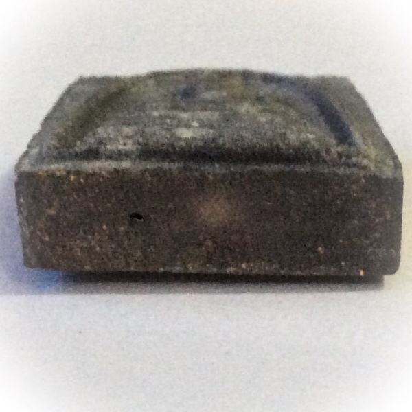 Two Takrut, and Sacred Powders are inserted into three hollow holes in the base of the amulet. One Takrut in inserted into the top edge.